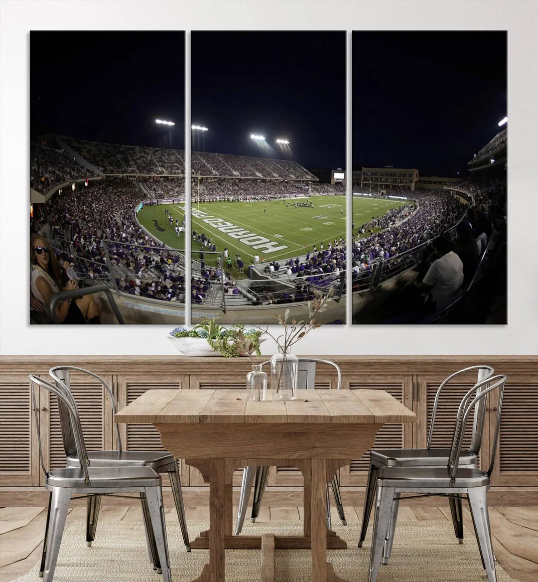 Immerse yourself in the vibrant energy of a packed football stadium at night with bright lights illuminating the field and stands, beautifully captured in the TCU Horned Frogs Football Team Print on premium canvas. This wall art features Fort Worth's Amon G. Carter Stadium.