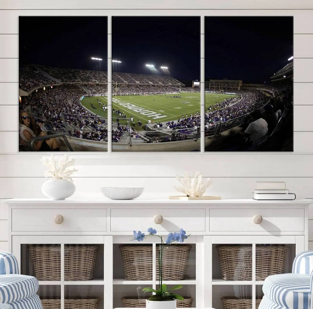 Immerse yourself in the vibrant energy of a packed football stadium at night with bright lights illuminating the field and stands, beautifully captured in the TCU Horned Frogs Football Team Print on premium canvas. This wall art features Fort Worth's Amon G. Carter Stadium.