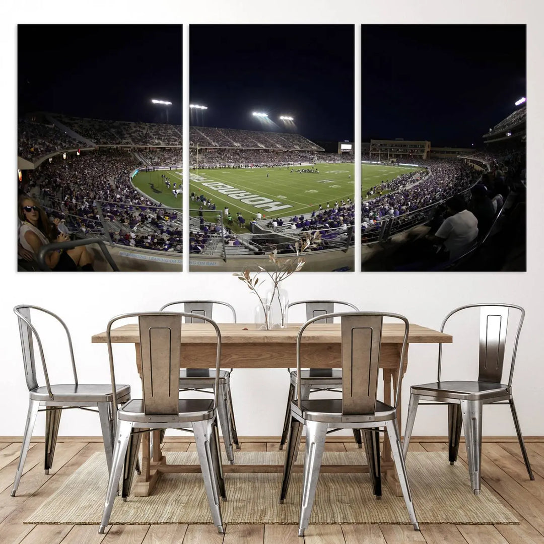 Immerse yourself in the vibrant energy of a packed football stadium at night with bright lights illuminating the field and stands, beautifully captured in the TCU Horned Frogs Football Team Print on premium canvas. This wall art features Fort Worth's Amon G. Carter Stadium.