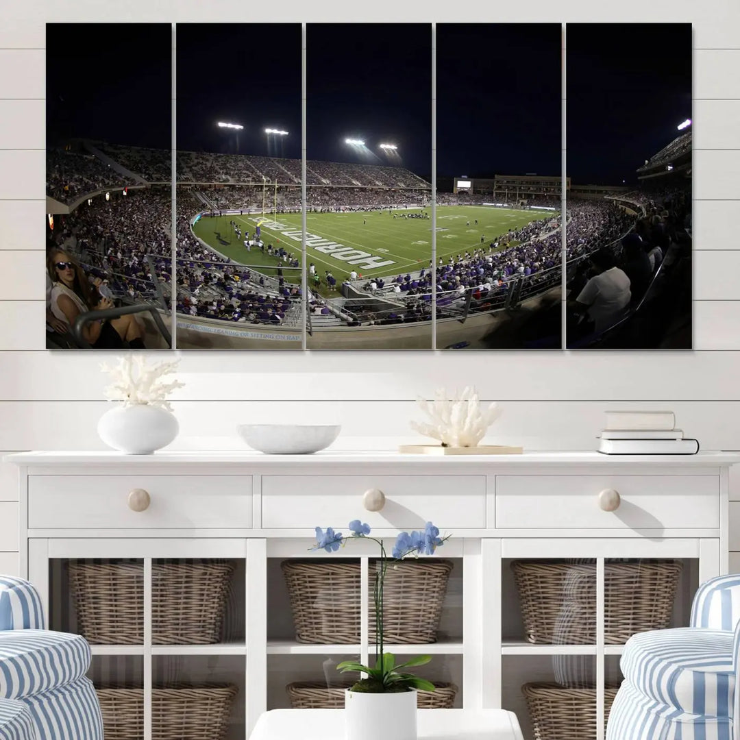 Immerse yourself in the vibrant energy of a packed football stadium at night with bright lights illuminating the field and stands, beautifully captured in the TCU Horned Frogs Football Team Print on premium canvas. This wall art features Fort Worth's Amon G. Carter Stadium.