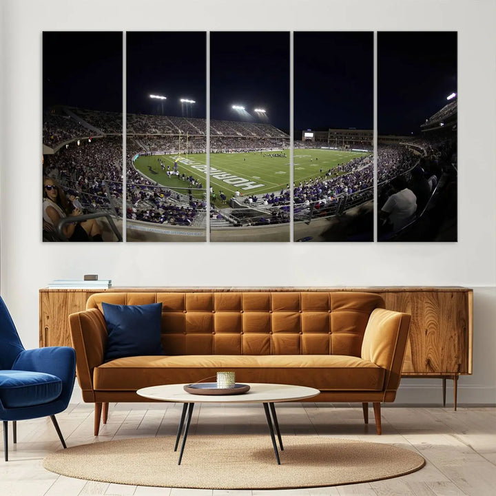 Immerse yourself in the vibrant energy of a packed football stadium at night with bright lights illuminating the field and stands, beautifully captured in the TCU Horned Frogs Football Team Print on premium canvas. This wall art features Fort Worth's Amon G. Carter Stadium.