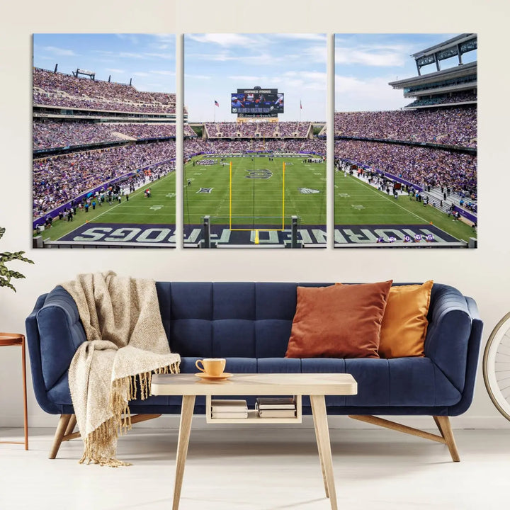 A living room features the TCU Horned Frogs Football Team Canvas Print, showcasing Carter Stadium with its green field and vibrant stands.