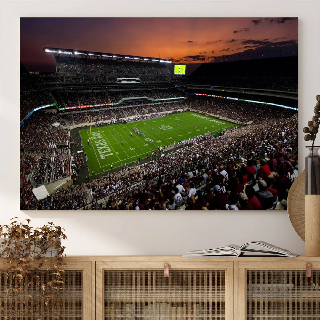 The Texas A&M University Aggies Football Team Print - College Station Kyle Field Stadium Wall Art Canvas Print captures a vibrant sunset casting a warm glow over the green field, bringing the scene to life.