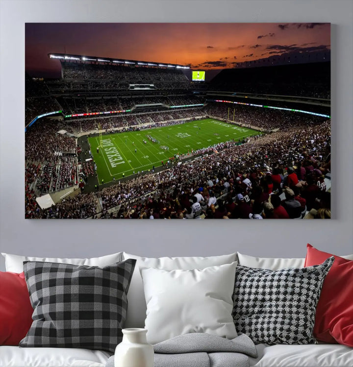 The Texas A&M University Aggies Football Team Print - College Station Kyle Field Stadium Wall Art Canvas Print captures a vibrant sunset casting a warm glow over the green field, bringing the scene to life.