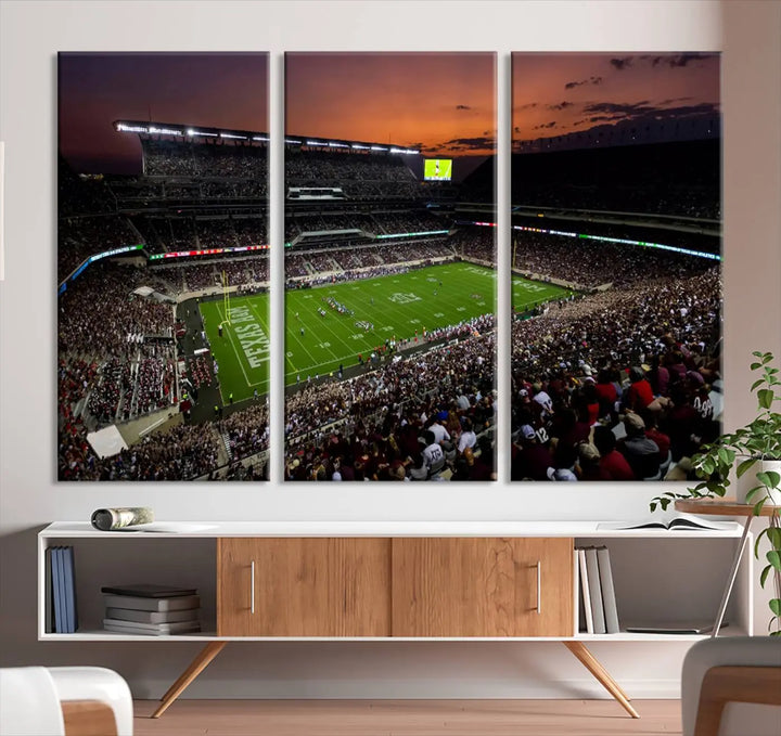 The Texas A&M University Aggies Football Team Print - College Station Kyle Field Stadium Wall Art Canvas Print captures a vibrant sunset casting a warm glow over the green field, bringing the scene to life.