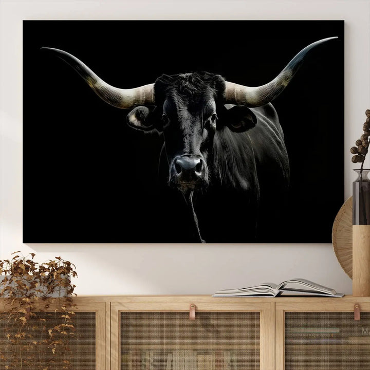 This sophisticated Texas Black Longhorn Bull Wall Art Canvas Print serves as an impressive triptych piece. The vivid depiction of the Western Texas cattle against the dark background enhances the elegance and boldness of the space.