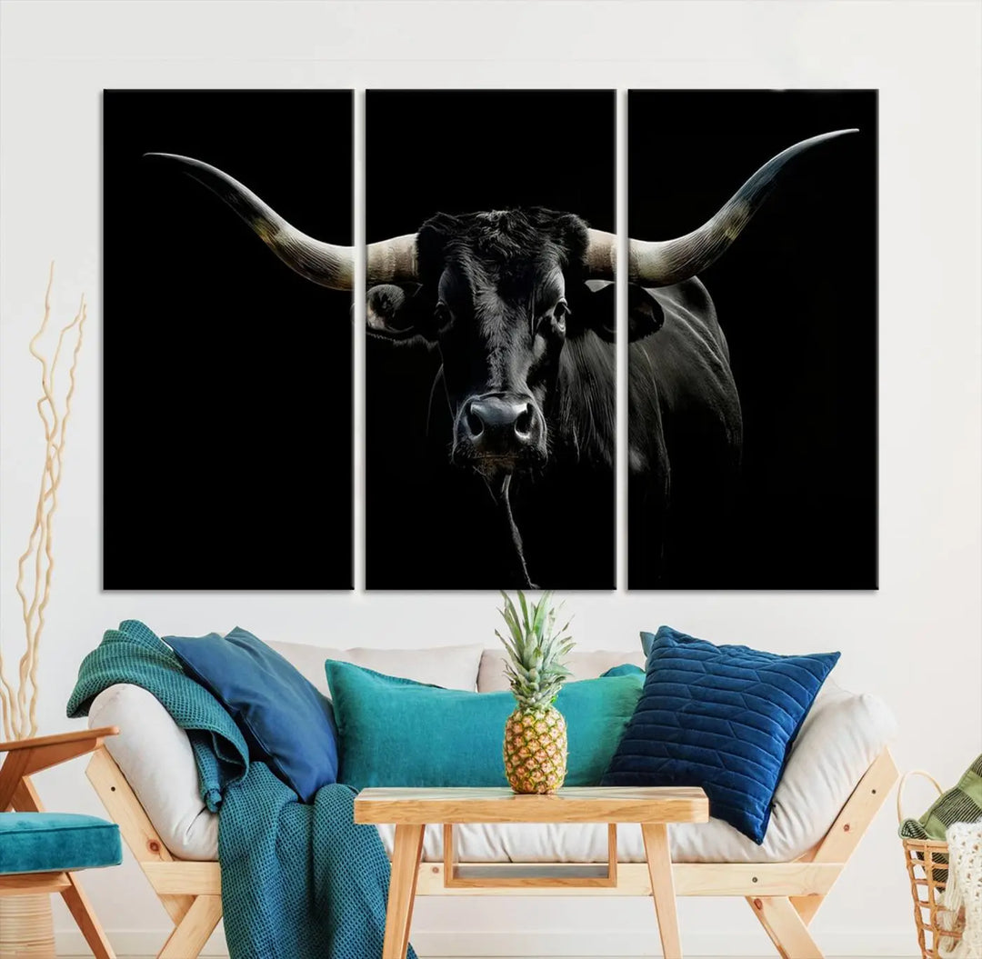 This sophisticated Texas Black Longhorn Bull Wall Art Canvas Print serves as an impressive triptych piece. The vivid depiction of the Western Texas cattle against the dark background enhances the elegance and boldness of the space.