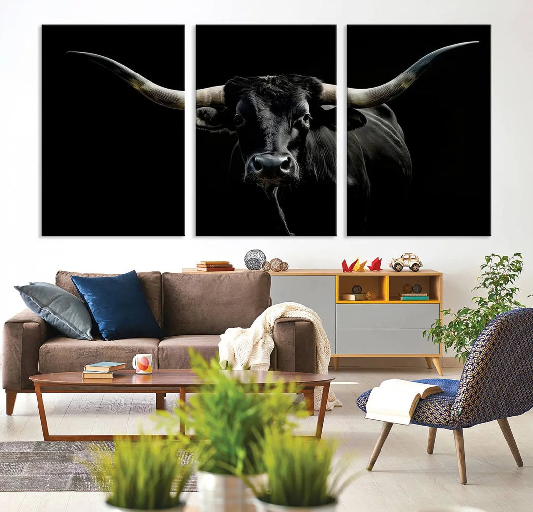 This sophisticated Texas Black Longhorn Bull Wall Art Canvas Print serves as an impressive triptych piece. The vivid depiction of the Western Texas cattle against the dark background enhances the elegance and boldness of the space.