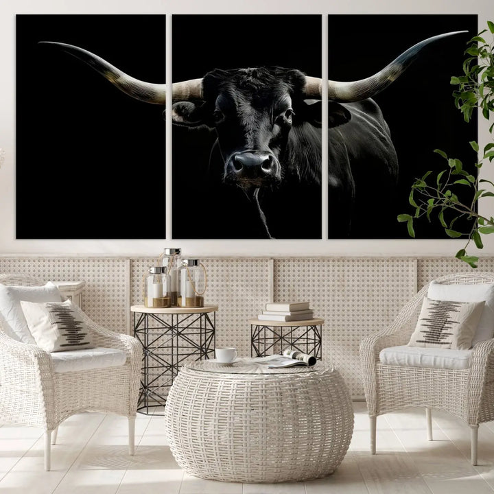 This sophisticated Texas Black Longhorn Bull Wall Art Canvas Print serves as an impressive triptych piece. The vivid depiction of the Western Texas cattle against the dark background enhances the elegance and boldness of the space.