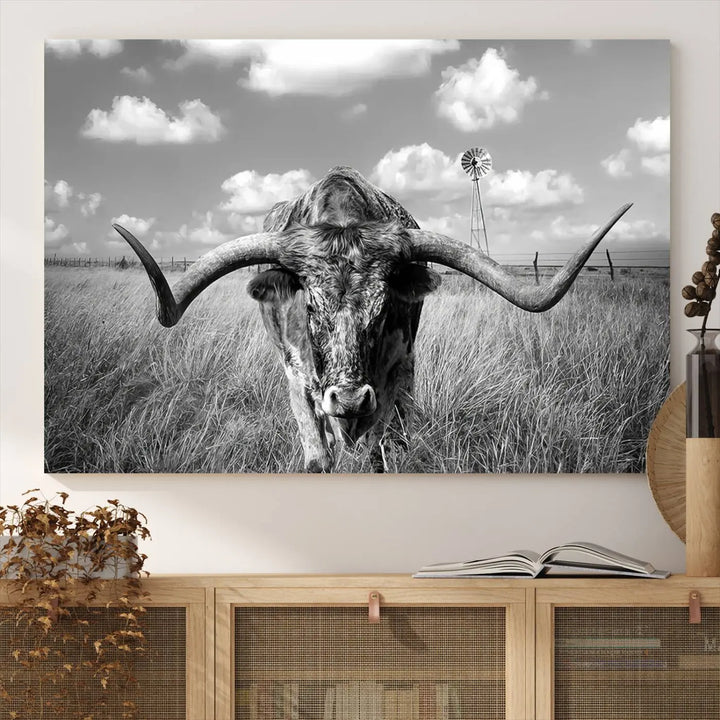 The Texas Cow Longhorn Wall Art Canvas Print features a black and white triptych of a longhorn steer in a grassy field, rendered with high-resolution clarity on museum quality canvas.