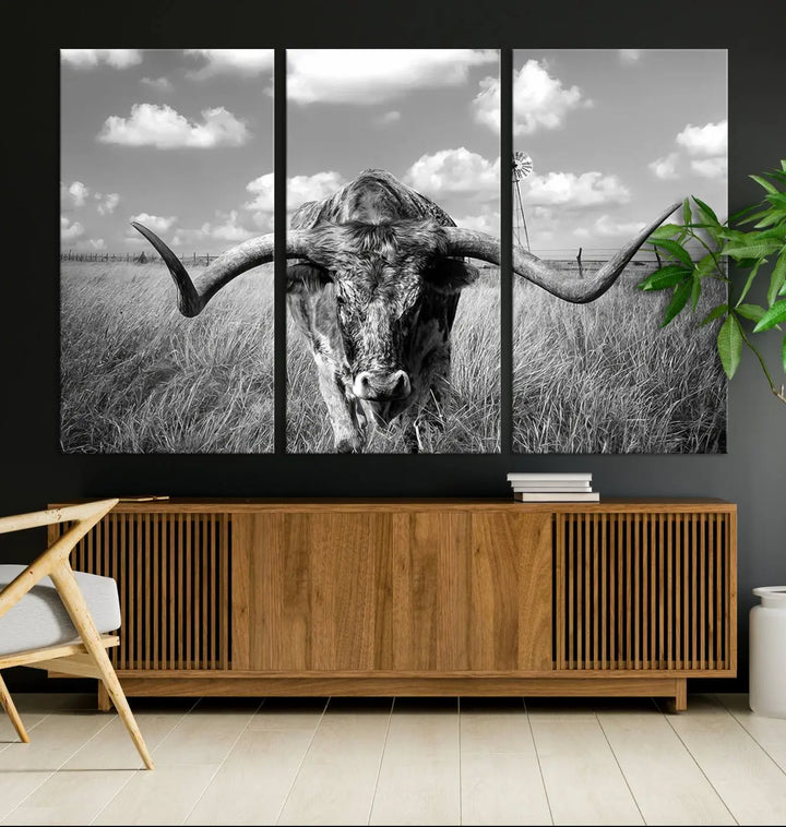 The Texas Cow Longhorn Wall Art Canvas Print features a black and white triptych of a longhorn steer in a grassy field, rendered with high-resolution clarity on museum quality canvas.