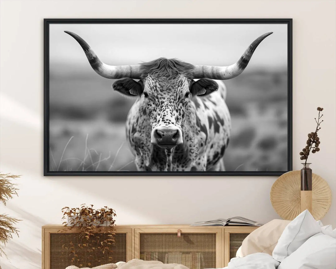 The Texas Cow Longhorn Wall Art Canvas Print features a striking black and white image of a Highland Longhorn Cow with large horns. This piece enhances the Western-inspired decor with its neutral tones and rustic accents.