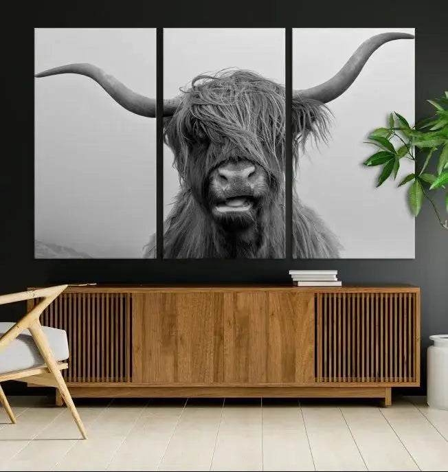 Texas Cow Wall Art Canvas Print in black and white, featuring a long-horned Highland cow, printed on museum-quality canvas with UV protection. It's perfect for enhancing any sophisticated space.