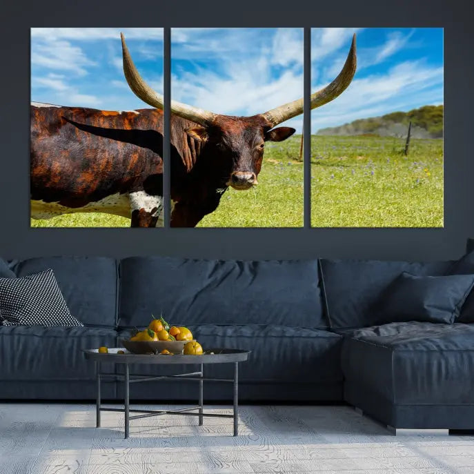 The Texas Longhorn Cow Wall Art Animal Canvas Print is a three-panel portrayal of a longhorn cow in a grassy field on museum-quality canvas with UV-protective coating.