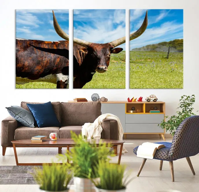 The Texas Longhorn Cow Wall Art Animal Canvas Print is a three-panel portrayal of a longhorn cow in a grassy field on museum-quality canvas with UV-protective coating.