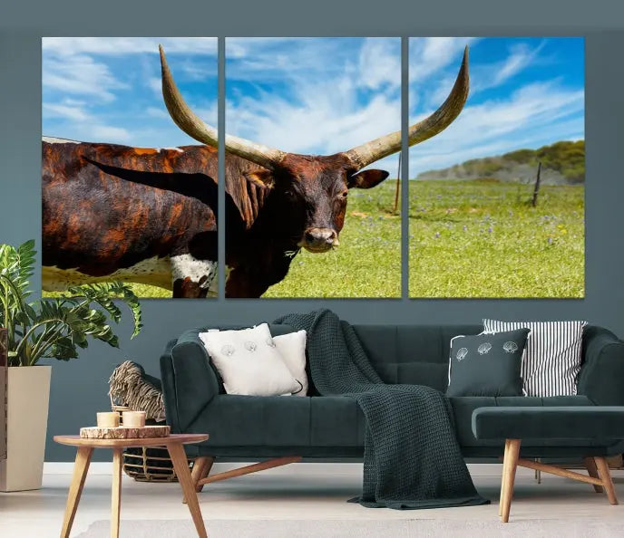 The Texas Longhorn Cow Wall Art Animal Canvas Print is a three-panel portrayal of a longhorn cow in a grassy field on museum-quality canvas with UV-protective coating.