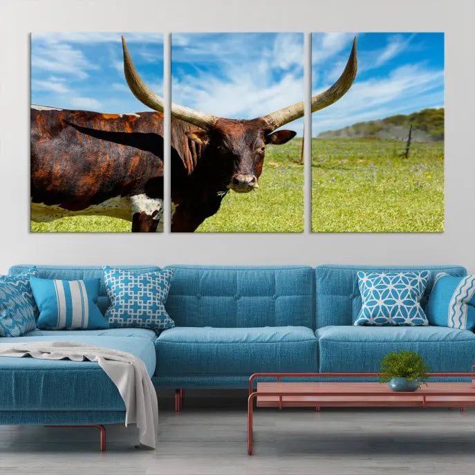 The Texas Longhorn Cow Wall Art Animal Canvas Print is a three-panel portrayal of a longhorn cow in a grassy field on museum-quality canvas with UV-protective coating.