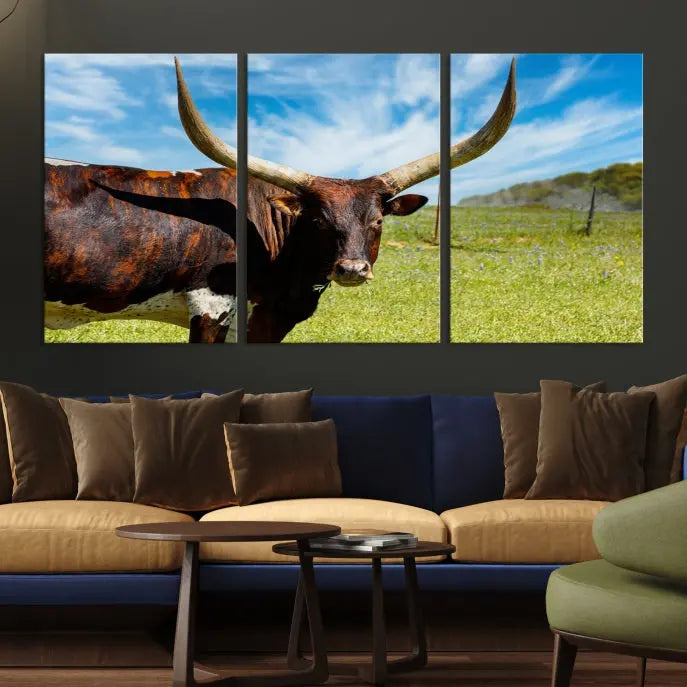 The Texas Longhorn Cow Wall Art Animal Canvas Print is a three-panel portrayal of a longhorn cow in a grassy field on museum-quality canvas with UV-protective coating.