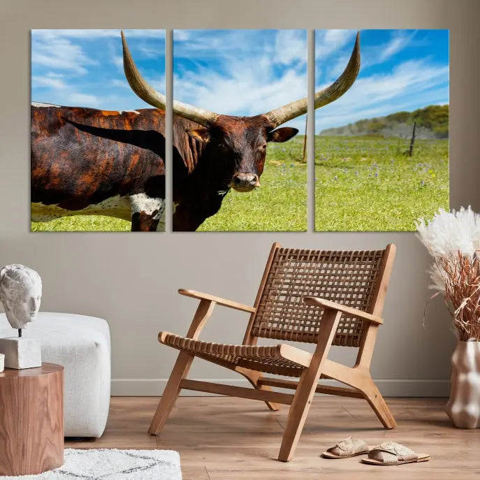 The Texas Longhorn Cow Wall Art Animal Canvas Print is a three-panel portrayal of a longhorn cow in a grassy field on museum-quality canvas with UV-protective coating.