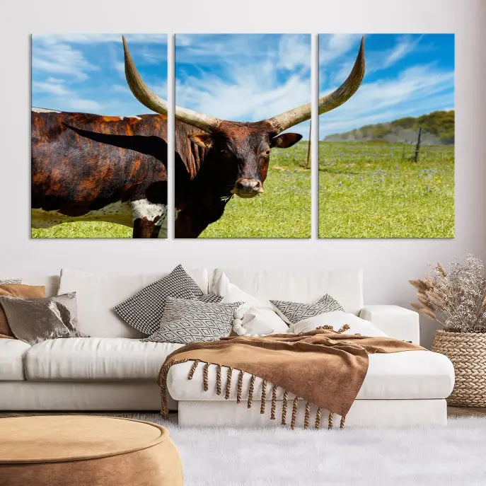 The Texas Longhorn Cow Wall Art Animal Canvas Print is a three-panel portrayal of a longhorn cow in a grassy field on museum-quality canvas with UV-protective coating.