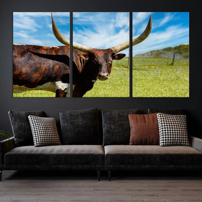 The Texas Longhorn Cow Wall Art Animal Canvas Print is a three-panel portrayal of a longhorn cow in a grassy field on museum-quality canvas with UV-protective coating.