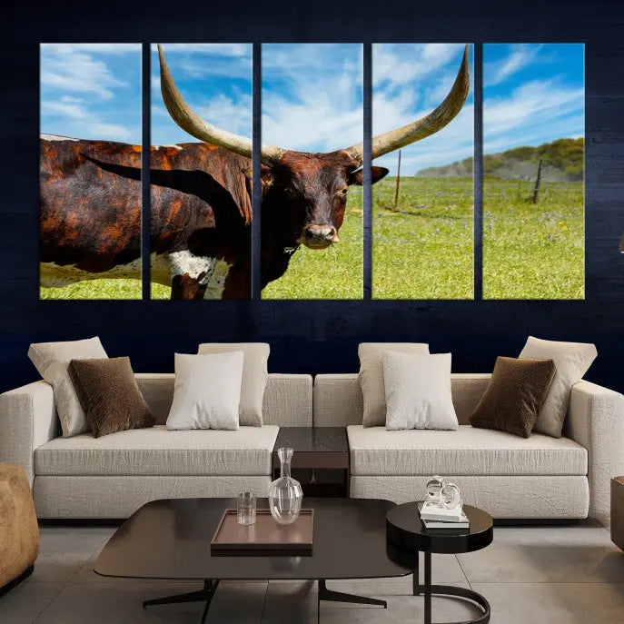 The Texas Longhorn Cow Wall Art Animal Canvas Print is a three-panel portrayal of a longhorn cow in a grassy field on museum-quality canvas with UV-protective coating.