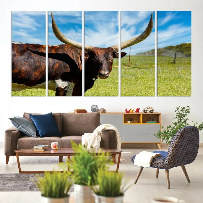 The Texas Longhorn Cow Wall Art Animal Canvas Print is a three-panel portrayal of a longhorn cow in a grassy field on museum-quality canvas with UV-protective coating.