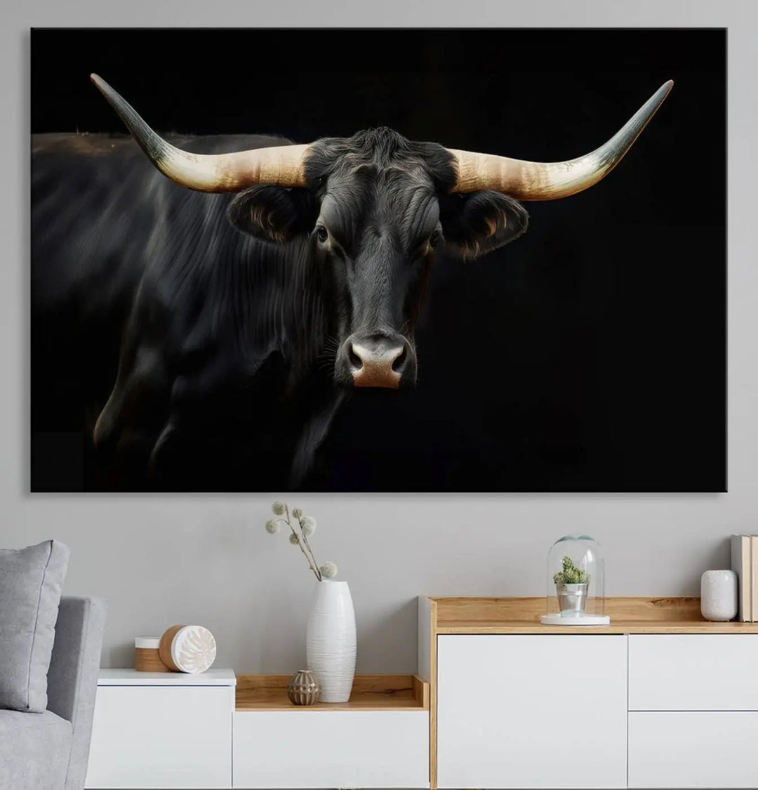 The living room exudes rustic charm with the Majestic Black Bull Wall Art Canvas Print, showcasing a Texas Longhorn cow with large horns.