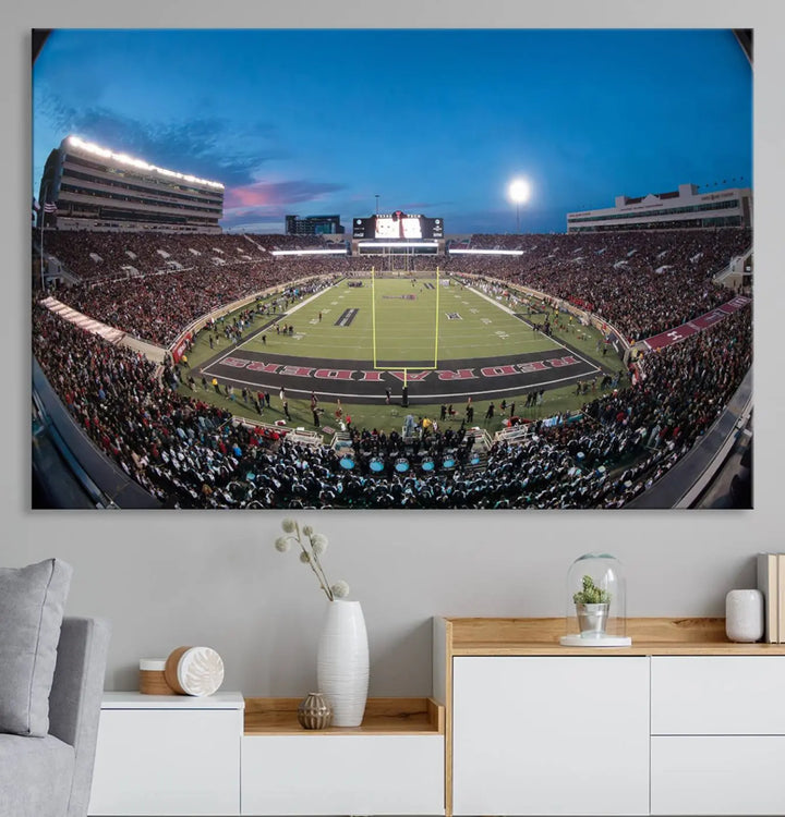 A gallery-quality triptych canvas of the Texas Tech Red Raiders football team print, showcasing Lubbock's Jones AT&T Stadium at twilight from the end zone, hangs on the wall. This stunning piece of wall art canvas print is handmade in the USA, elevating any space with its dynamic and immersive presence.