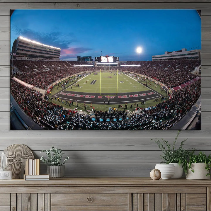 A gallery-quality triptych canvas of the Texas Tech Red Raiders football team print, showcasing Lubbock's Jones AT&T Stadium at twilight from the end zone, hangs on the wall. This stunning piece of wall art canvas print is handmade in the USA, elevating any space with its dynamic and immersive presence.