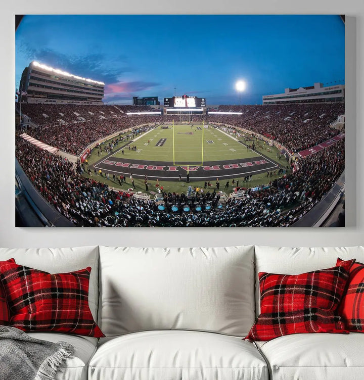 A gallery-quality triptych canvas of the Texas Tech Red Raiders football team print, showcasing Lubbock's Jones AT&T Stadium at twilight from the end zone, hangs on the wall. This stunning piece of wall art canvas print is handmade in the USA, elevating any space with its dynamic and immersive presence.