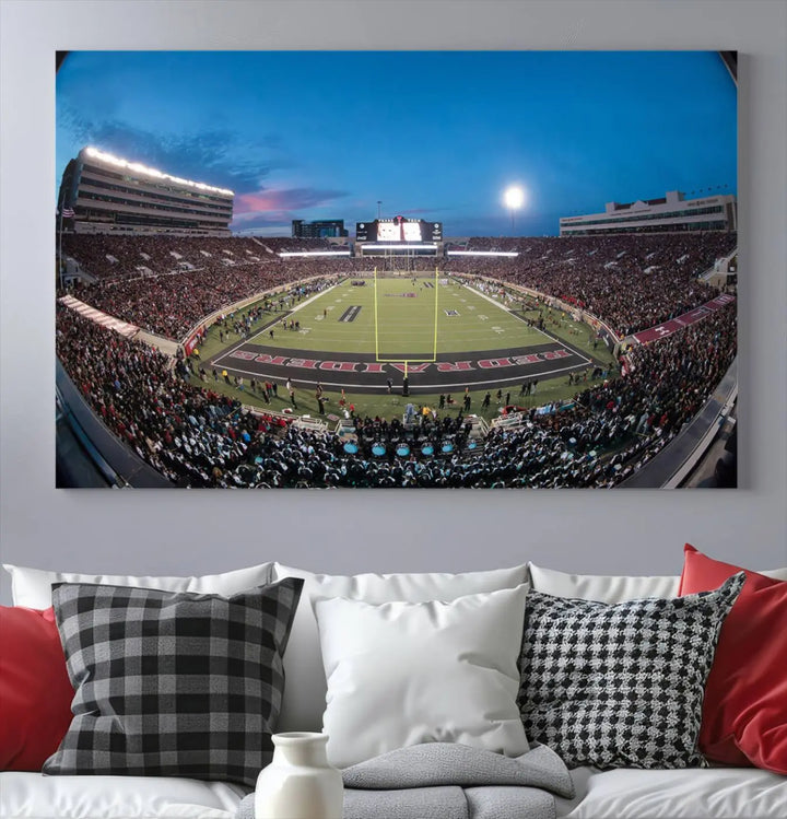 A gallery-quality triptych canvas of the Texas Tech Red Raiders football team print, showcasing Lubbock's Jones AT&T Stadium at twilight from the end zone, hangs on the wall. This stunning piece of wall art canvas print is handmade in the USA, elevating any space with its dynamic and immersive presence.