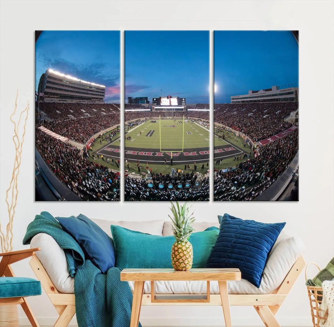 A gallery-quality triptych canvas of the Texas Tech Red Raiders football team print, showcasing Lubbock's Jones AT&T Stadium at twilight from the end zone, hangs on the wall. This stunning piece of wall art canvas print is handmade in the USA, elevating any space with its dynamic and immersive presence.