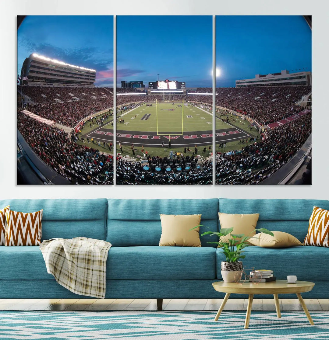 A gallery-quality triptych canvas of the Texas Tech Red Raiders football team print, showcasing Lubbock's Jones AT&T Stadium at twilight from the end zone, hangs on the wall. This stunning piece of wall art canvas print is handmade in the USA, elevating any space with its dynamic and immersive presence.