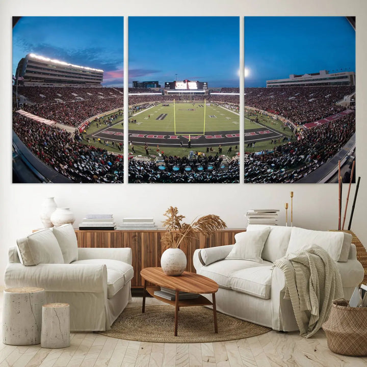 A gallery-quality triptych canvas of the Texas Tech Red Raiders football team print, showcasing Lubbock's Jones AT&T Stadium at twilight from the end zone, hangs on the wall. This stunning piece of wall art canvas print is handmade in the USA, elevating any space with its dynamic and immersive presence.