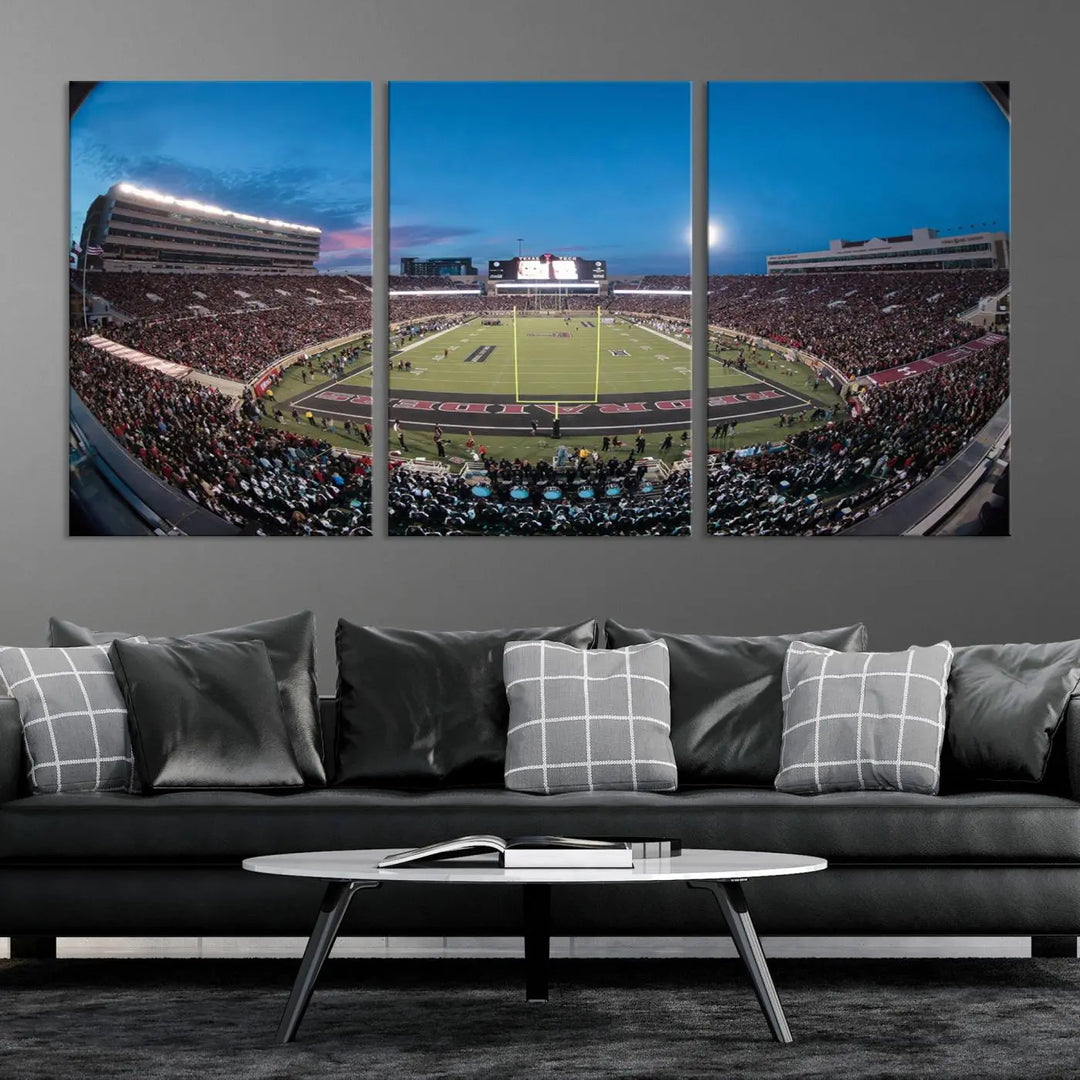 A gallery-quality triptych canvas of the Texas Tech Red Raiders football team print, showcasing Lubbock's Jones AT&T Stadium at twilight from the end zone, hangs on the wall. This stunning piece of wall art canvas print is handmade in the USA, elevating any space with its dynamic and immersive presence.