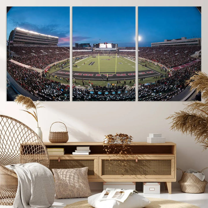 A gallery-quality triptych canvas of the Texas Tech Red Raiders football team print, showcasing Lubbock's Jones AT&T Stadium at twilight from the end zone, hangs on the wall. This stunning piece of wall art canvas print is handmade in the USA, elevating any space with its dynamic and immersive presence.