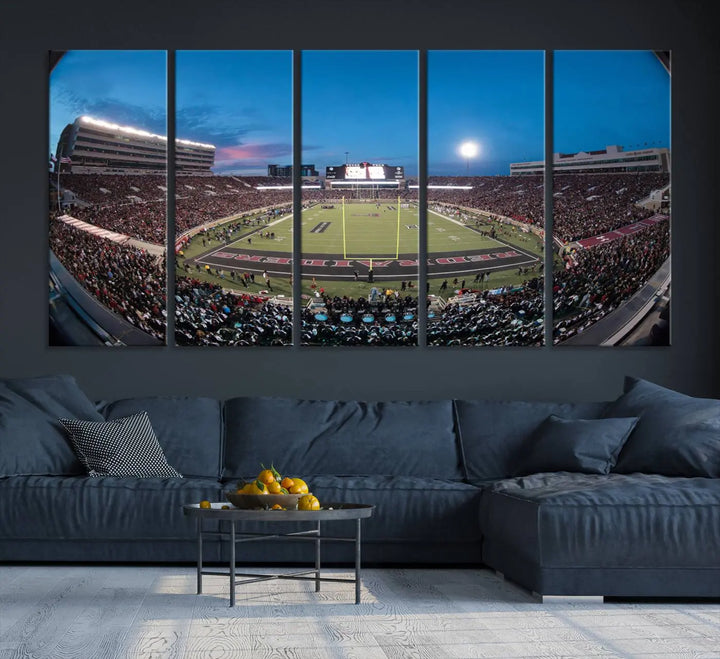 A gallery-quality triptych canvas of the Texas Tech Red Raiders football team print, showcasing Lubbock's Jones AT&T Stadium at twilight from the end zone, hangs on the wall. This stunning piece of wall art canvas print is handmade in the USA, elevating any space with its dynamic and immersive presence.