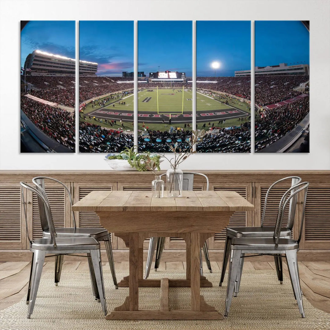 A gallery-quality triptych canvas of the Texas Tech Red Raiders football team print, showcasing Lubbock's Jones AT&T Stadium at twilight from the end zone, hangs on the wall. This stunning piece of wall art canvas print is handmade in the USA, elevating any space with its dynamic and immersive presence.