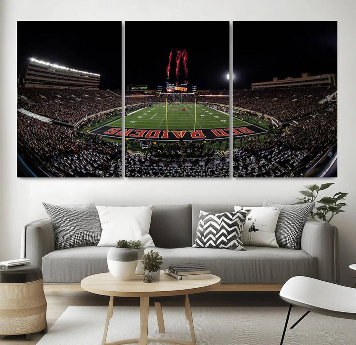 A modern living room is beautifully decorated with the "Texas Tech Red Raiders Football Team Print - Lubbock Jones AT&T Stadium Wall Art Canvas Print," showcasing a bustling football stadium. This gallery-quality canvas print exudes vibrancy and elegance.