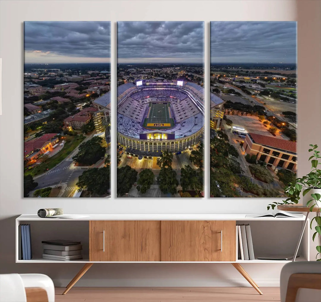 A stunning three-panel aerial view of the Louisiana State University Tigers' Tiger Stadium at dusk, set against a bustling cityscape. This captivating scene is elegantly displayed as a canvas artwork in a sleek wood frame, creating an impressive piece of wall art.