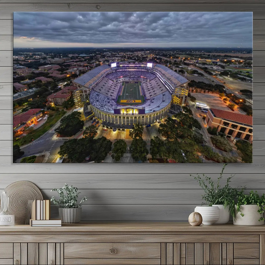 A stunning three-panel aerial view of the Louisiana State University Tigers' Tiger Stadium at dusk, set against a bustling cityscape. This captivating scene is elegantly displayed as a canvas artwork in a sleek wood frame, creating an impressive piece of wall art.