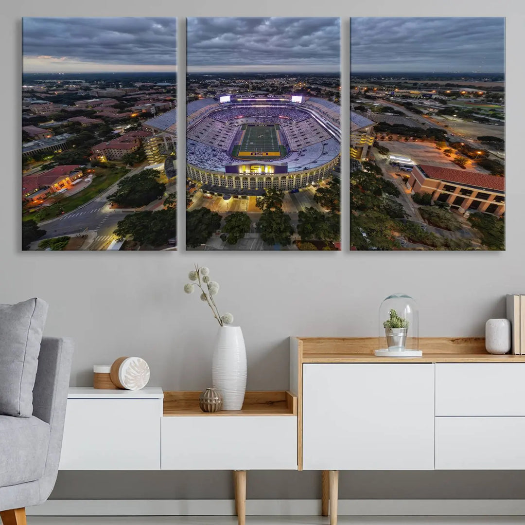 A stunning three-panel aerial view of the Louisiana State University Tigers' Tiger Stadium at dusk, set against a bustling cityscape. This captivating scene is elegantly displayed as a canvas artwork in a sleek wood frame, creating an impressive piece of wall art.