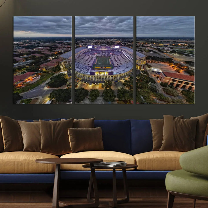 A stunning three-panel aerial view of the Louisiana State University Tigers' Tiger Stadium at dusk, set against a bustling cityscape. This captivating scene is elegantly displayed as a canvas artwork in a sleek wood frame, creating an impressive piece of wall art.