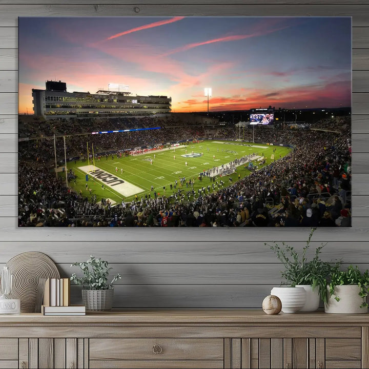 The living room is highlighted by a stunning triptych of the University of Connecticut UCONN Huskies Football Team at sunset on premium canvas, showcasing the East Hartford Pratt & Whitney Stadium.