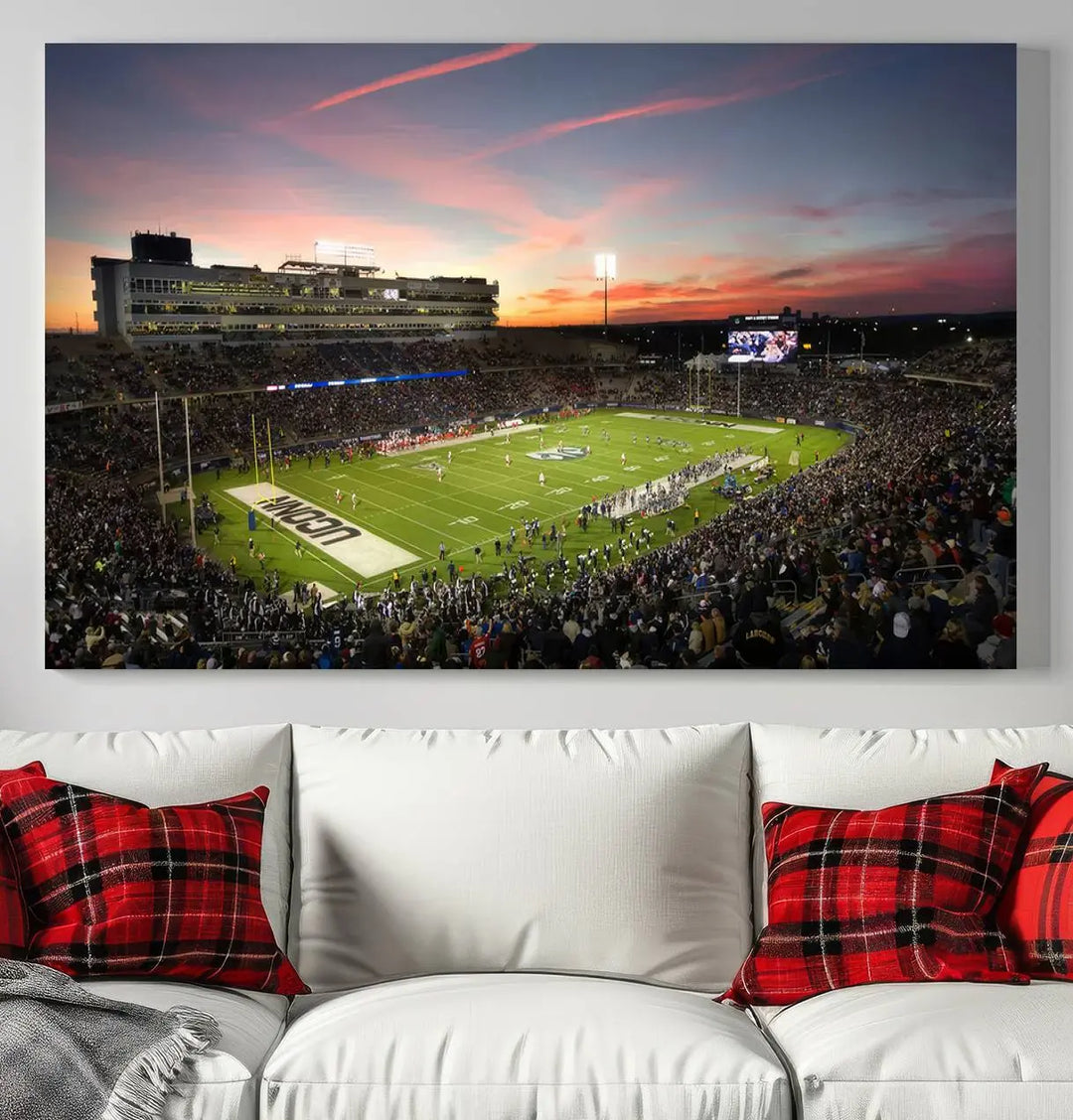 The living room is highlighted by a stunning triptych of the University of Connecticut UCONN Huskies Football Team at sunset on premium canvas, showcasing the East Hartford Pratt & Whitney Stadium.