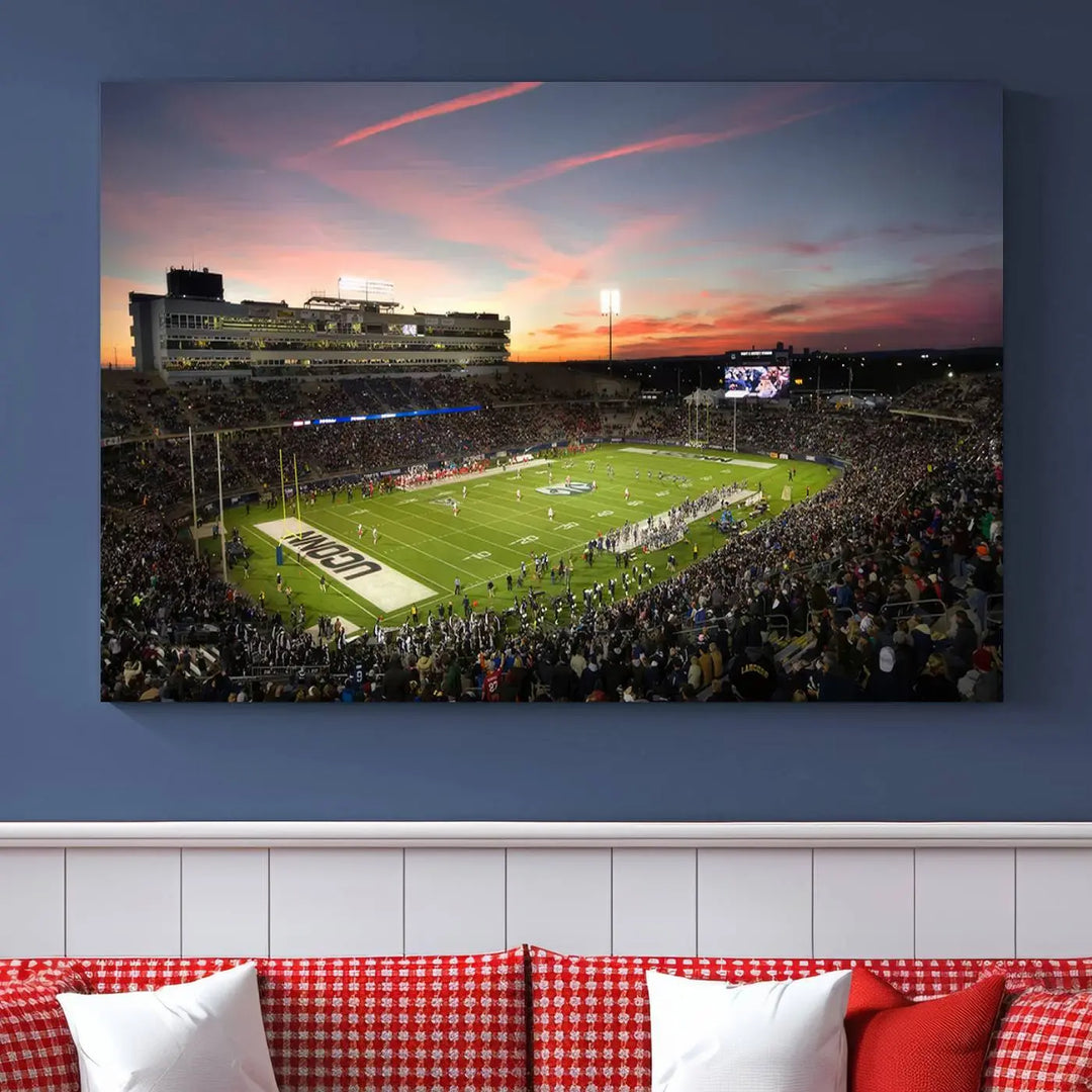 The living room is highlighted by a stunning triptych of the University of Connecticut UCONN Huskies Football Team at sunset on premium canvas, showcasing the East Hartford Pratt & Whitney Stadium.