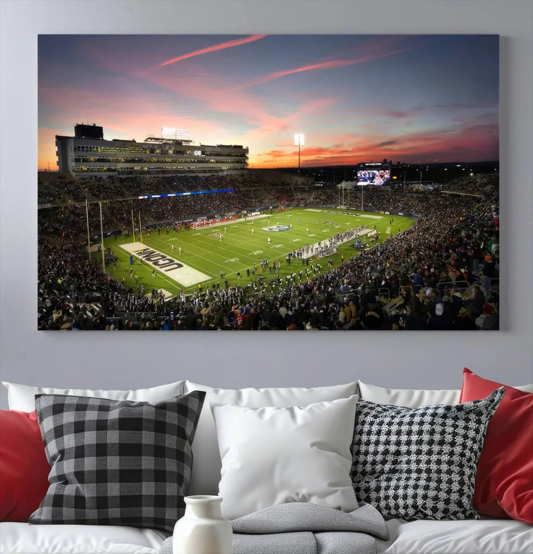 The living room is highlighted by a stunning triptych of the University of Connecticut UCONN Huskies Football Team at sunset on premium canvas, showcasing the East Hartford Pratt & Whitney Stadium.