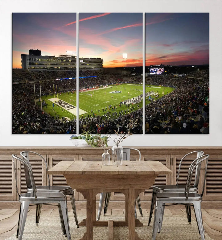 The living room is highlighted by a stunning triptych of the University of Connecticut UCONN Huskies Football Team at sunset on premium canvas, showcasing the East Hartford Pratt & Whitney Stadium.