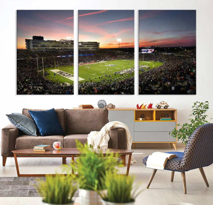 The living room is highlighted by a stunning triptych of the University of Connecticut UCONN Huskies Football Team at sunset on premium canvas, showcasing the East Hartford Pratt & Whitney Stadium.